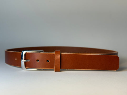 Reddish brown leather belt with a silver buckle on a gray background