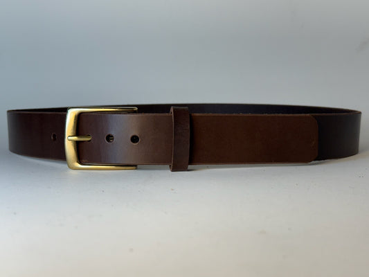 Dark brown leather belt with a gold buckle on a gray background