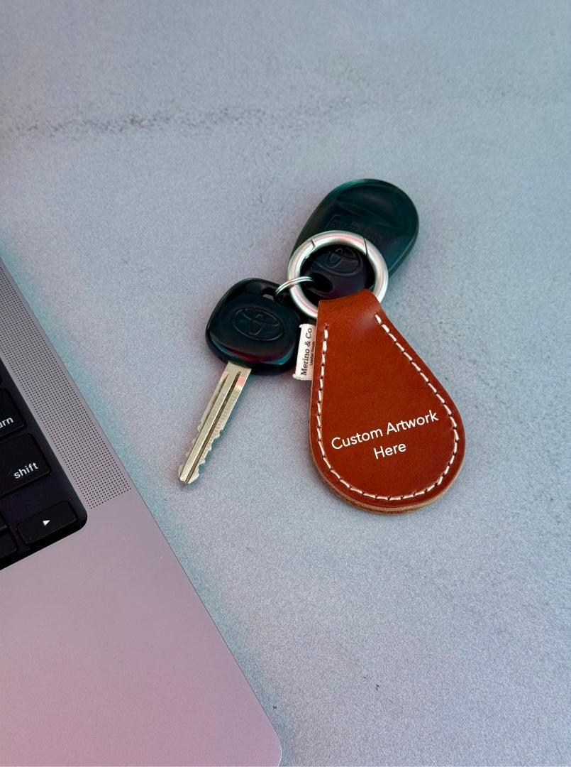 Keychain with leather tag on a laptop keyboard